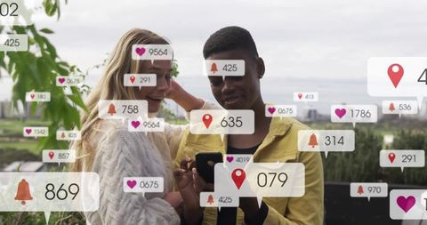 Young couple sharing smartphone on rooftop with floating social notification overlays