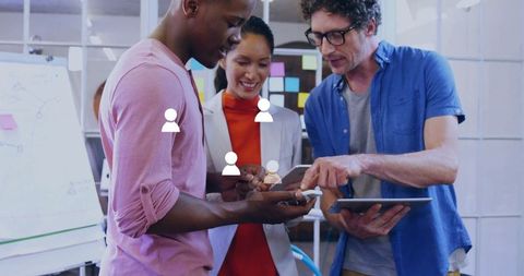 Diverse Coworkers in Office Collaborating with Smartphone and Tablet