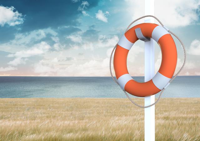 Lifebuoy with rope hanging against a serene ocean and sky background. Ideal for use in safety and rescue themes, maritime and beach-related content, summer vacation promotions, and outdoor adventure advertisements.