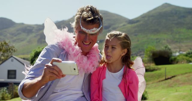 Father and Daughter in Fairy Costumes Taking Selfie Outdoors - Download Free Stock Images Pikwizard.com