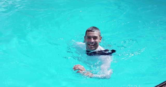 Man swimming in pool with cheerful smile - Download Free Stock Images Pikwizard.com