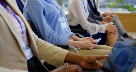 Diverse Business Professionals Using Devices at Seminar Conference