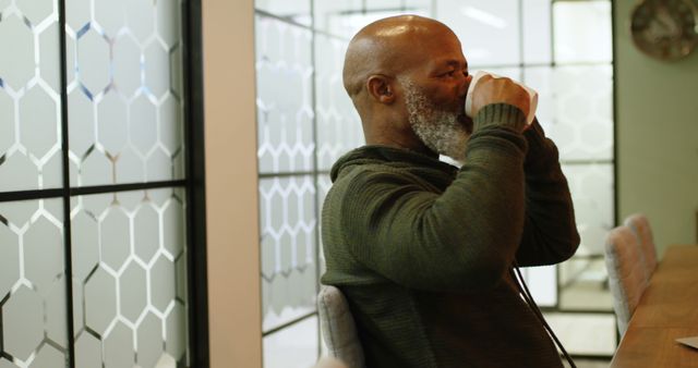 Mature Man Drinking Coffee in Modern Office - Download Free Stock Images Pikwizard.com