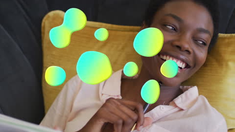 Joyful African American Woman Relaxing with Colorful Digital Shapes
