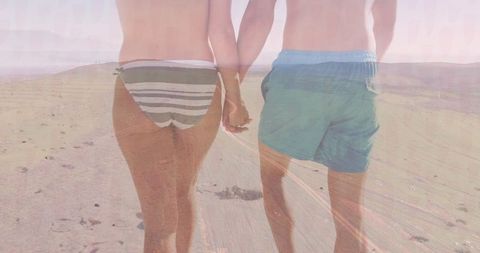 Romantic Beach Stroll at Sunset with Couple Holding Hands