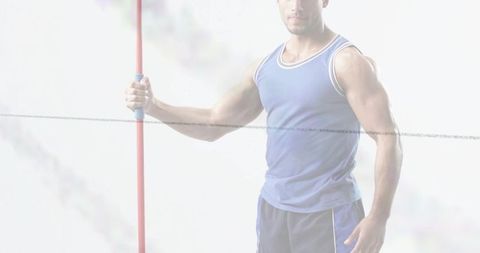 Muscular athlete holding red pole and rope in high-key studio cropped fitness close-up