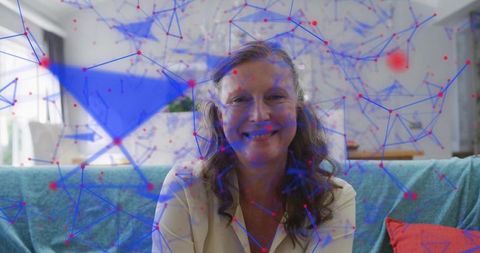 Mature woman smiling on sofa with digital network overlay for home office comfort