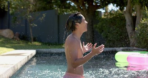 Asian Teen Having Fun in Backyard Pool Playful Moment