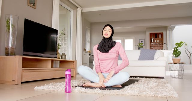 Muslim Woman Meditating at Home in Casual Clothes - Download Free Stock Images Pikwizard.com