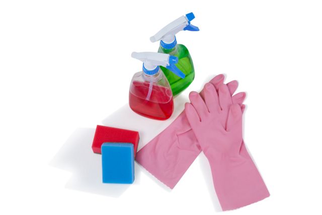 This image shows essential cleaning supplies including spray bottles filled with detergent, sponges, and pink rubber gloves. Ideal for use in articles, advertisements, and blogs related to household cleaning, hygiene, and sanitation. Perfect for illustrating cleaning tips, product reviews, and home maintenance guides.