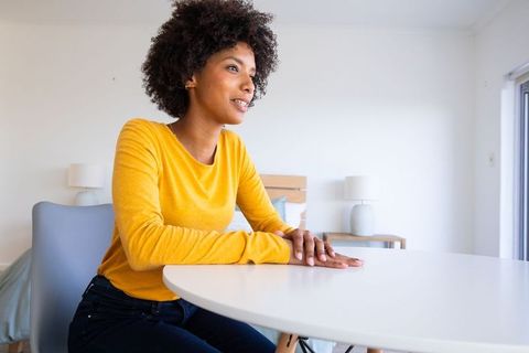 Casual Woman in Cozy Bedroom Enjoying Natural Light