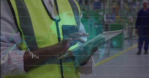 Warehouse Worker Using Tablet with Data Visualizations in Industrial Environment