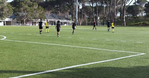 Youth soccer players engaged in game focusing on teamwork and strategy