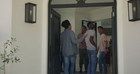 Excited Friends Reuniting at Home Entrance