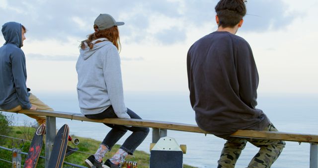 Group of Teenagers Relaxing by Seaside, Enjoying Outdoor Scenery - Download Free Stock Images Pikwizard.com