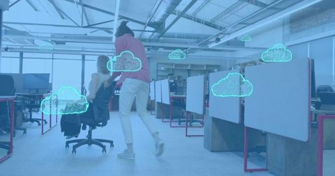 Pushing colleague on rolling chair in modern open-plan office with cloud icons