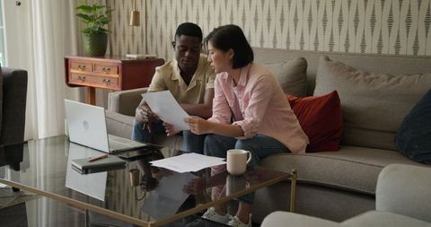 Diverse Colleagues Collaborating in Modern Living Room Environment