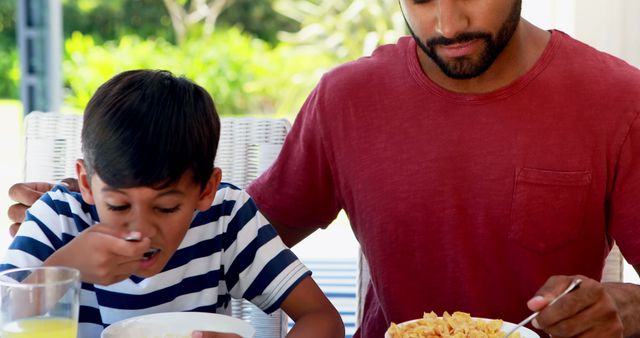 Father and Son Eating Breakfast Together at Outdoor Table - Download Free Stock Images Pikwizard.com