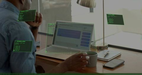 Holding coffee while working on chat interface with futuristic hud overlays at home office
