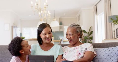 Multigenerational Family Laughing Together in Modern Living Room