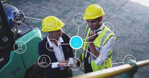 Engineers discussing construction plan with digital network interface