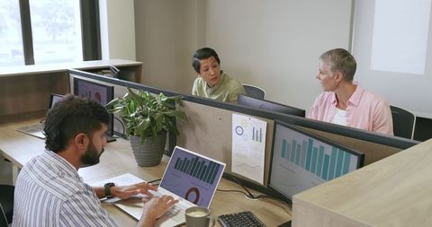 Diverse Team Discussing Analytics in Modern Office Space