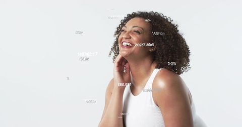 Smiling woman touching neck with floating data overlays on bright minimalist background
