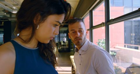 Focused Colleagues in Modern Office Discussing Project