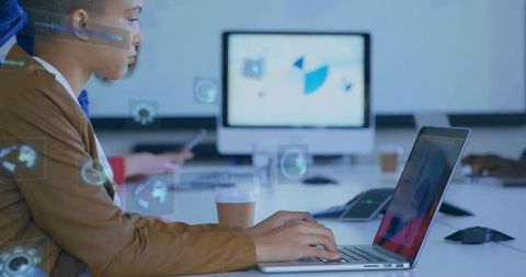 Focused professional woman working with laptop in modern office setting