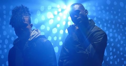 Artistic representation of musical collaboration under moody stage lighting