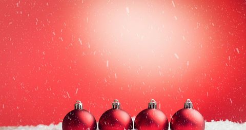 Snow Falling on Red Christmas Baubles with Festive Background - Download Free Stock Images Pikwizard.com