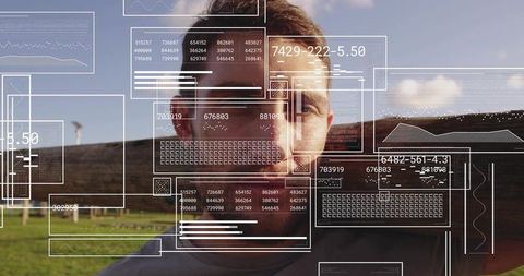 Young man using augmented reality hud overlays in open field for future interface concept