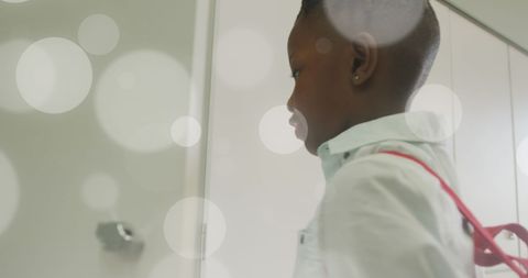 African American Schoolboy Standing at Locker Door in Classroom - Download Free Stock Images Pikwizard.com