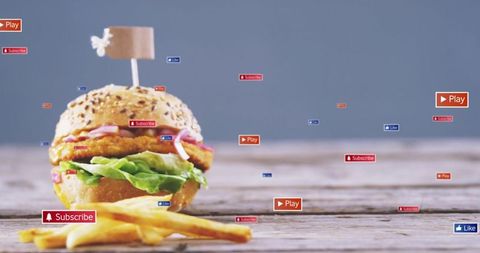 Showcasing sesame seed chicken burger with fries on rustic table and floating social badges