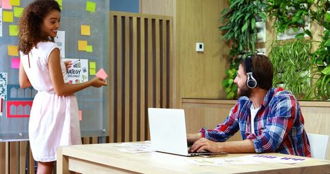 Business Professionals Collaborating on Project in Modern Office