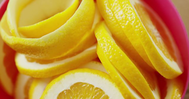 Colorful close-up shot of freshly sliced lemons, perfect for use in food and beverage promotions, healthy living blogs, and recipe books looking to add a splash of color and freshness.