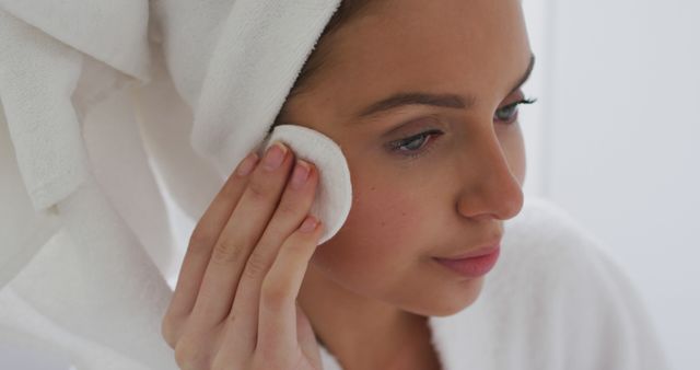 Woman Cleansing Face with Cotton Pad Post-Shower - Download Free Stock Images Pikwizard.com