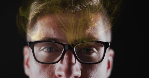 Staring man wearing black rectangular glasses with neon green smoke overlay