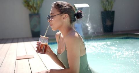 Woman Relaxing by Poolside Enjoying Refreshing Iced Tea - Download Free Stock Images Pikwizard.com