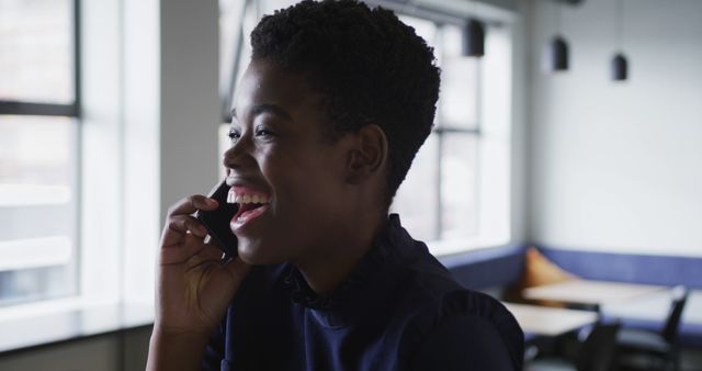 Smiling Young Woman Talking on Phone in Modern Office - Download Free Stock Images Pikwizard.com