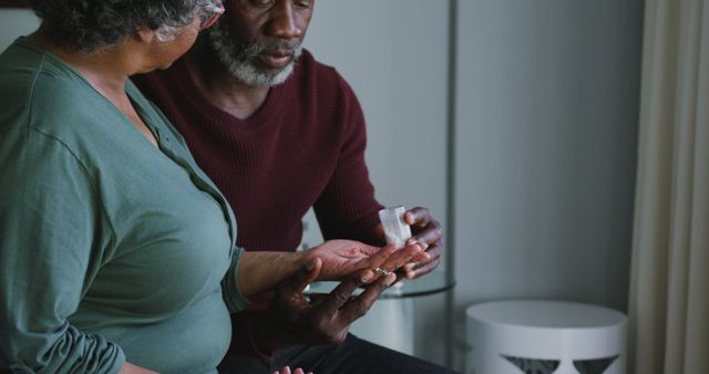 Elderly Man Assisting Wife with Medication at Home - Download Free Stock Images Pikwizard.com