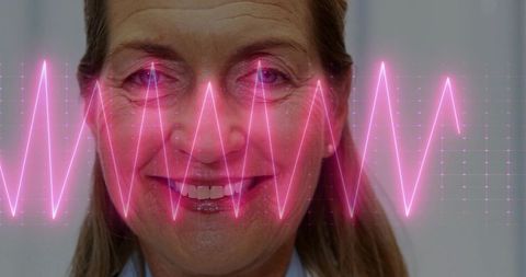 Elderly woman smiling with vibrant ecg overlay