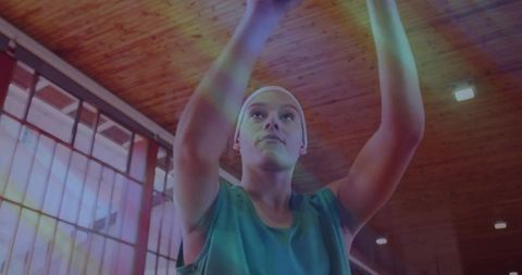 Athlete Prepares Basketball Shot in Indoor Gym