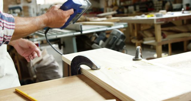 Carpenter using leveling tool on wooden plank in workshop - Download Free Stock Images Pikwizard.com