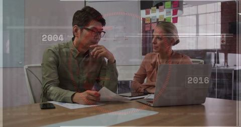 Business Colleagues Collaborating with Technology in Modern Office