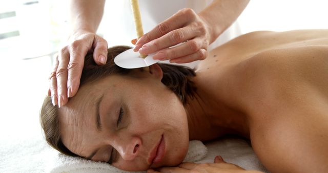 Woman Receiving Ear Candling Therapy for Relaxation and Wellness - Download Free Stock Images Pikwizard.com