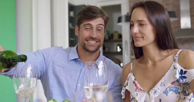 Smiling Man Pouring Wine for Woman at Dinner - Download Free Stock Images Pikwizard.com