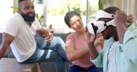 Friends Experiencing Virtual Reality Together in Living Room