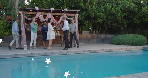 Backyard pool wedding couple exchanging vows under pergola lights bride holding bouquet