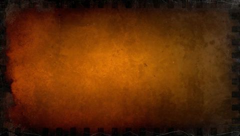Vintage burnt orange grunge backdrop with sprocket edge and gritty distressed film texture